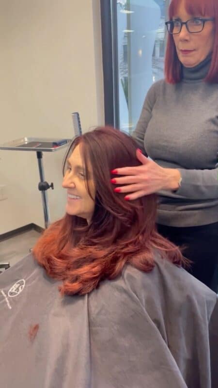 Hairstylist Teresa with a client training a hairstylist apprentice