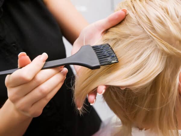Hair coloring in a beauty salon in blonde. Hairdressing services.