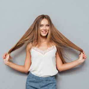 Young beautiful girl with long hair posing after a dry damaged hair treatment