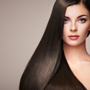 Beautiful woman with long smooth hair from permanent hair straightening